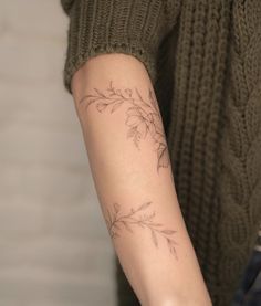 a woman with a tattoo on her arm