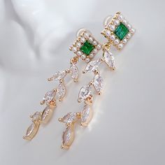 * DETAILS * This listing is for a pair of earrings only. - Emerald Colored Crystal Post Earrings  - CZ Paved Gold Leaf Charms, 18K Gold plated Brass Leaves Charm Size: 35x9mm 👉🏻For more earrings, see https://www.etsy.com/shop/JinnysJewelryBySeJin ------------------------------------------------ * CARE TIPS * ⭐️TO PREVENT TARNISH: Keep your jewellery in airtight plastic bags. It won't tarnish if it isn't exposed to air. The worst place to leave your jewellery is in a steamy bathroom. Wipe with a soft cloth after wearing. - Perfumes: Be sure any perfume or lotions are completely absorbed into skin. - Hair products: Apply all hair products before putting on jewelry. - Swimming: Remove all jewelry before swimming or getting into hot tubes. - No sunlight: Store away from heat, direct sunlight Bridesmaids Earrings, Special Jewelry, Leaf Charms, Plastic Bags, Bridesmaid Earrings, Polish Jewelry, Color Crystal, Hair Products, Care Tips