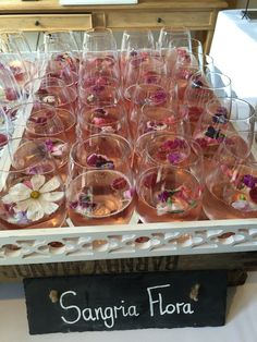 there are many wine glasses with flowers in them