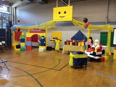 children's birthday party setup with legos and decorations on the floor in an indoor gym