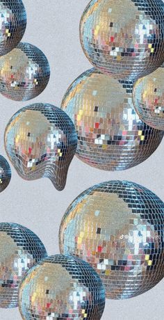 several shiny disco balls are shown in this image