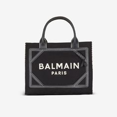 Join the style ranks of Balmain with the B-Army tote bag – hailing from a collection that draws on the House’s military influences. The roomy silhouette is crafted from canvas and trimmed with leather, framing the esteemed Balmain logo embroidered front and center that’s sure to command attention. Balmain Bag, Logo Monogramme, Embroidered Tote Bag, Embroidered Tote, Balmain Paris, Small Tote Bag, Dion Lee, Pierre Balmain, Engraved Logo