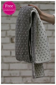 a hand holding a gray knitted bag with white polka dots on it and text overlay that reads free crochet pattern