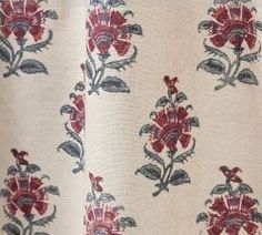 a close up view of a red and blue flowered fabric on a white background