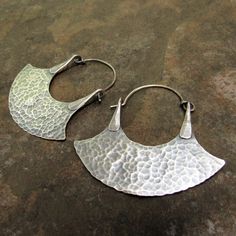 "Our signature rustic tribal blade hoop earrings in sterling silver are crafted with the utmost attention to detail. Powerful and beautiful, large silver hoops handcrafted from solid sterling stock and hammer forged for texture and strength. Oxidized and brushed to finish. Handmade 20 gauge sterling silver ear wires complete them. Earrings measure 1 and 7/8\" or 4.7cm from top of ear wire and are 1 and 7/8\" or 4.7cm wide at their widest point. Lightweight for all their size. Rustic, urban triba Jewelry Queen, Metalsmith Jewelry, Small Silver Hoop Earrings, Metalsmithing Jewelry, Mixed Metal Earrings, Mixed Metal Jewelry, Ear Candy, Earrings Large, African Jewelry