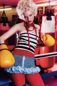 a woman with blonde hair wearing boxing gloves