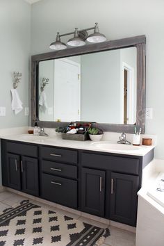 a bathroom with a sink, mirror and rug on the floor in front of it