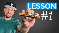 a man is holding a harmonica in one hand and the word lesson on the other