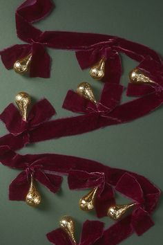 two pieces of red velvet with gold bells on them