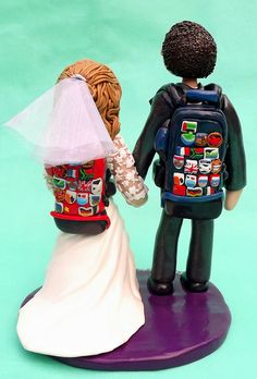 a bride and groom figurine standing next to each other on a purple base