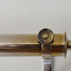 a close up of a metal handle on a white wall