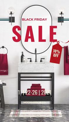 a black friday sale sign in front of a bathroom sink with red towels hanging on the wall