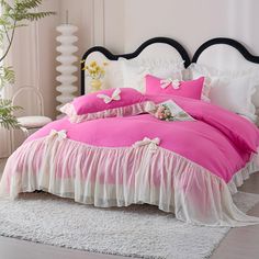 a pink bed with white ruffled bedspread and matching comforter is shown