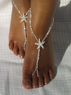 a woman's foot wearing a white beaded starfish ankle chain on her wedding day