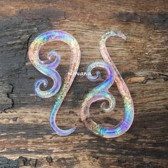 the letter s is made out of holographic paint and has swirly designs on it