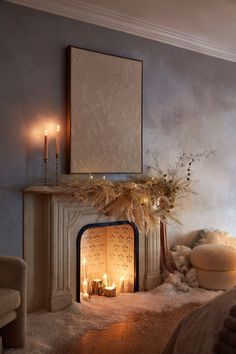 a living room with a fire place and candles