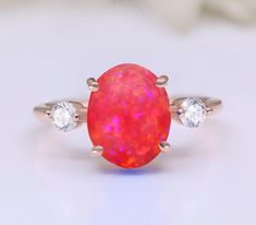 Ring Specifications & Details: Engagement/Wedding/Bridal Ring Stone Size: 10.00 X 8.00 mm Side Gemstone:  Moissanite Stone Type: Lab Created Pink Opal Gemstone Metal Used: 925 Sterling Silver Plating Available: Rhodium/ Yellow/ Rose Gold We apply 2.5 micron of thicker plating on our rings. Stone CTW: 3.10 ctw  SKU  You may also favorite our studio for continuous updates on new designs and special discount coupons. Their would be special sale in the beginning of every month.  We work in all semi Rings Pink, Rings Stone, Pink Fire, Opal Engagement Ring, Fire Opal Ring, Opal Engagement, Engagement Rings Opal, Ring Stone, Pink Ring