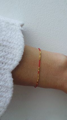 Before placing an order please check the estimated shipping times. If you need your order in a hurry shipping upgrades are available. Thank you. This delicate red string of fate bracelet is beautiful in its simplicity. D E T A I L S *It is made with the teeny tiniest gold vermeil Karen Hill tribe nuggets that come from Thailand. Beads measure around 1.3mm. They are handmade using traditional silversmith techniques passed down through generations. They have a 98% and above silver content and are Minimalist Red Beaded Bracelet With Tiny Beads, Red Friendship Bracelets With Gold Beads As Gift, Red Friendship Bracelet With Gold Beads As Gift, Dainty Red Beaded Bracelets With Tiny Beads, Dainty Red Bracelet With Sliding Knot, Dainty Red Beaded Bracelets For Everyday, Dainty Friendship Bracelets With Spacer Beads As Gift, Red String Of Fate Bracelet, Silversmith Techniques