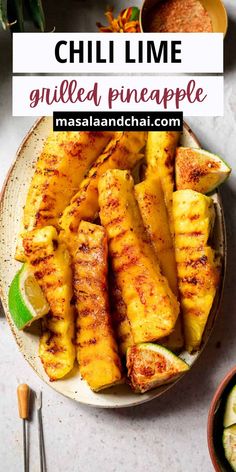 grilled pineapple on a plate with cucumber and lime