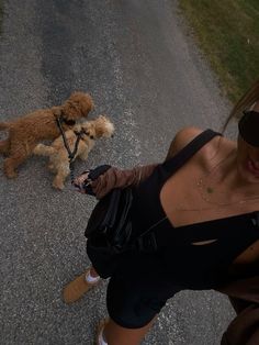 a woman is walking her dog on a leash