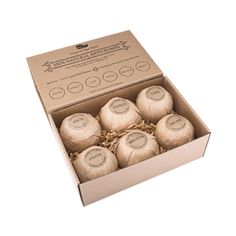 six soap balls in a cardboard box on a white background