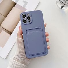 a person holding up a phone case with a finger holder on it's back