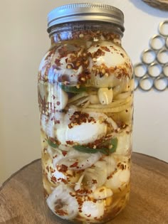 a jar filled with food sitting on top of a wooden table