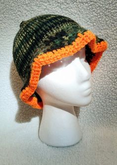 Handcrafted Camouflage Bucket Hat with neon orange brim accent 🧡💚 Size: Fits Teens & Adults Craftsmanship: Expertly knitted and crocheted with precision and care. Design: Earthy blend of camouflage colors with a neon brim will help you stand out!  Materials: Made with high-quality, vegan-friendly acrylic yarns. Ethos: Proudly woman-owned business, crafting with compassion and eco-conscious practices. Embrace your style this spring with the bright pop of orange in this earthy bucket hat, meticulously handcrafted for comfort and flair. 💚🧡 💚 visit my shop for more💚 https://www.etsy.com/shop/HandmadebyHollyween Orange Adjustable Beanie Hat, Adjustable Orange Beanie Hat, Adjustable Orange Beanie, Green Brimmed Crochet Hat For Outdoor, Green Yarn Crochet Hat For Outdoor, Handmade Orange Crochet Beanie Hat, Orange Crochet Hat, One Size Fits Most, Handmade Orange Cap, Crochet Orange Hat, One Size Fits Most