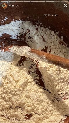 a wooden spoon in a bowl filled with flour next to a brown and white dish