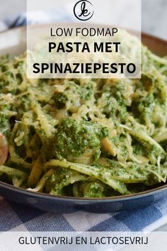 pasta with spinach pesto in a skillet on a checkered table cloth