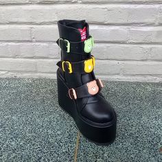 The Yru Dune Lo Care Bear Black Platform Boot Has Different Color Care Bear Heads On Each Adjustable Front Strap, As Well As A 2.75" Platform, 6" Heel, And Back Zipper. #Yru #Yrudunelo #Dunelocarebear #Yrucarebear Black Edgy Platform Boots With Ankle Strap, Casual Black Platform Boots For Alternative Fashion, Alternative Style Black Boots For Spring, Alternative Style Black Spring Boots, Black Punk Boots With Ankle Strap, Black Platform Boots With Ankle Strap, Black Punk Ankle Strap Boots, Pink Platform Boots, Yru Shoes