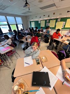 students are sitting at their desks in the classroom