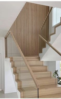 the stairs are made of wood and have glass balconies