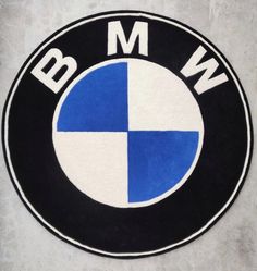 the bmw logo is shown in black and blue on a white background with gray spots