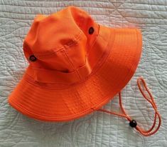 This is a New Outdoor Cap Blaze Orange Bucket Boonie Hat with Adjustable Drawcord for Secure Fit. Perfect for Hunting, Fishing, Camping and other outdoor activities. It is size Small/Medium (Head circumference measures approximately 21" to 22" around). Please measure to make sure of fit. Please see photos. Thanks for Looking! Adjustable Wide Brim Bucket Hat For Fishing, Adjustable Bucket Hat For Fishing, Adjustable Fit Bucket Hat With Curved Brim For Fishing, Casual Adjustable Orange Bucket Hat, Fishing Bucket Hat With Short Brim, Adjustable Short Brim Bucket Hat For Fishing, Adjustable Bucket Hat For Fishing With Short Brim, Casual Adjustable Sun Hat For Fishing, Solid Color Fishing Sun Hat Cap