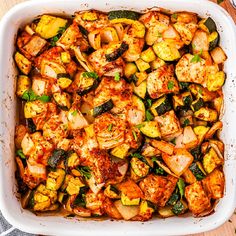 a casserole dish with chicken, zucchini and squash