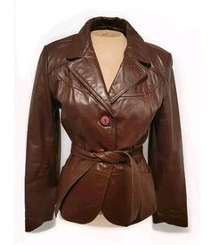 Classic belted button up brown leather women's coat will never be out of style. Nice condition with some normal wear to the leather. Measurements: Arm length: 30" Armpit to armpit flat across: 17.5" Total length top to bottom not including collar: 24" Brown Belted Leather Jacket With Long Sleeves, Brown Belted Fitted Leather Jacket, Vintage Brown Blazer For Office, Retro Brown Leather Jacket For Work, Office Brown Belted Outerwear, Retro Brown Leather Blazer, Brown Retro Blazer For Work, Vintage Brown Leather Jacket With Buttons, Retro Brown Single Breasted Leather Jacket