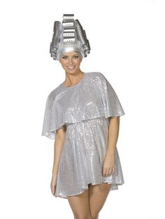 a woman in a silver dress with a metal headpiece on top of her head