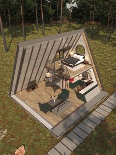 an aerial view of a small cabin in the woods