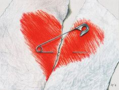 a red heart with a pair of scissors on it