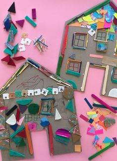 a house made out of construction paper surrounded by cut outs and other crafting supplies