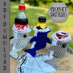 three crocheted mice sitting on top of a table next to a bottle of soda