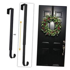 an image of a black door with a wreath on the front and handlebars