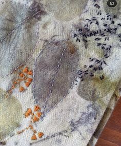 a close up of a piece of fabric with leaves on it