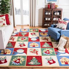 a living room filled with furniture and a christmas tree on top of a colorful rug