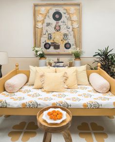 a living room with a couch, coffee table and potted plants