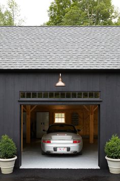 a car is parked in the garage with its door open