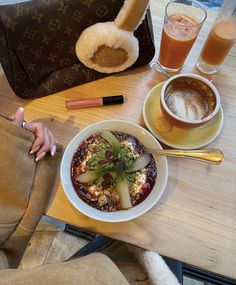 a table topped with two bowls of food and drinks