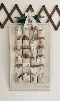 a christmas stocking display hanging on a wall with stockings and presents attached to it