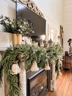 a fireplace decorated with greenery and candles